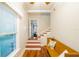 Inviting entryway with hardwood floors, staircase, and a charming wooden bench at 37439 Meridian Ave, Dade City, FL 33525