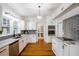 Bright kitchen with white cabinets, marble countertops, and stainless steel appliances at 37439 Meridian Ave, Dade City, FL 33525