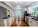 Open-concept kitchen featuring marble countertops, stainless steel appliances, and eat-in breakfast nook at 37439 Meridian Ave, Dade City, FL 33525