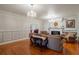 Bright living room featuring a fireplace, hardwood floors, and elegant chandeliers at 37439 Meridian Ave, Dade City, FL 33525
