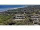 Aerial view of townhomes close to the water with mature trees providing natural shade and beauty at 381 Estero Ct, Safety Harbor, FL 34695
