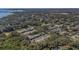 An aerial view shows the neighborhood townhomes near a body of water in a wooded area at 381 Estero Ct, Safety Harbor, FL 34695