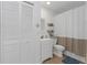 Well-lit bathroom with a white vanity and a toilet at 381 Estero Ct, Safety Harbor, FL 34695