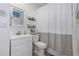 Bright bathroom boasts white vanity, toilet and shower/tub combo at 381 Estero Ct, Safety Harbor, FL 34695