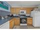 Well-equipped kitchen with light wood cabinetry, offering practical storage and cooking space at 381 Estero Ct, Safety Harbor, FL 34695