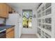 Bright kitchen featuring a white refrigerator, ample cabinet space, and a window with view of exterior at 381 Estero Ct, Safety Harbor, FL 34695