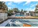Community pool with lounge chairs and shuffleboard at 381 Estero Ct, Safety Harbor, FL 34695