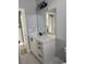 Bathroom featuring a single vanity with white countertops, modern black fixtures, and stylish overhead lighting at 4202 N 15Th St, Tampa, FL 33610