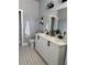 Bathroom featuring a double vanity with white countertops, modern black fixtures, and stylish decor at 4202 N 15Th St, Tampa, FL 33610