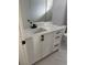 Bathroom single vanity with a modern black faucet, drawers, and marble tile flooring at 4202 N 15Th St, Tampa, FL 33610