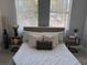 Cozy bedroom with a comfortable bed, decorative pillows, and stylish side tables with lamps at 4202 N 15Th St, Tampa, FL 33610
