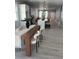 Open concept dining area with modern decor, wooden table, stylish chairs, and gray flooring at 4202 N 15Th St, Tampa, FL 33610