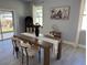 Dining area featuring a wooden table, neutral decor, and ample natural light from nearby windows at 4202 N 15Th St, Tampa, FL 33610