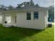 Back of house features covered patio and grassy backyard at 4202 N 15Th St, Tampa, FL 33610