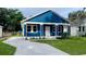 Newly constructed home with blue siding and a small front yard at 4202 N 15Th St, Tampa, FL 33610