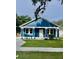 Charming blue house with a white trim, front yard, and driveway at 4202 N 15Th St, Tampa, FL 33610