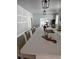 Open concept kitchen with a large island, quartz countertops, bar seating, and modern lighting fixtures at 4202 N 15Th St, Tampa, FL 33610