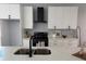 Modern kitchen featuring stainless sink, white cabinets, quartz countertops, and black hardware and appliances at 4202 N 15Th St, Tampa, FL 33610