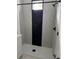 Modern tiled shower with black hardware, a rainfall showerhead, and a sleek design at 4202 N 15Th St, Tampa, FL 33610