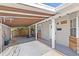 Carport with a white door and wood accents, leading to the entrance of the house at 4231 Shore Acres Ne Blvd, St Petersburg, FL 33703