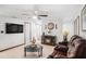 Living room with brown couches, a fireplace, and a large TV at 4522 W Knox St, Tampa, FL 33614