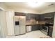 Modern kitchen with stainless steel appliances and dark cabinets at 504 Maple Pointe Dr, Seffner, FL 33584