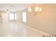 Living room with tile floors, neutral walls, and a chandelier at 504 Maple Pointe Dr, Seffner, FL 33584