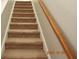 Carpeted staircase with wooden handrail at 504 Maple Pointe Dr, Seffner, FL 33584