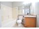 Clean bathroom with tub, toilet, and vanity with wood cabinets at 504 Maple Pointe Dr, Seffner, FL 33584