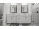 Double vanity bathroom with modern fixtures and a large mirror at 5805 Grand Sonata Ave, Lutz, FL 33558