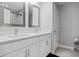 Bathroom with double vanity, quartz countertop and large mirrors at 5805 Grand Sonata Ave, Lutz, FL 33558
