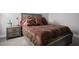 Well-lit bedroom with nightstand and dresser at 5805 Grand Sonata Ave, Lutz, FL 33558