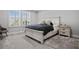 Bright bedroom with carpeted floors and a large window at 5805 Grand Sonata Ave, Lutz, FL 33558