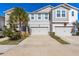 Two-story townhome with attached two-car garage and landscaped front yard at 5805 Grand Sonata Ave, Lutz, FL 33558