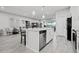 Modern kitchen with white cabinetry and a large island at 5805 Grand Sonata Ave, Lutz, FL 33558