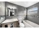 Updated bathroom with grey tile, a bathtub, and modern vanity at 5857 25Th S St, St Petersburg, FL 33712