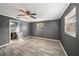 Bedroom with grey walls, wood-look tile floors, and ensuite bathroom at 5857 25Th S St, St Petersburg, FL 33712