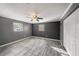 Spacious bedroom with grey walls and wood-look tile floors at 5857 25Th S St, St Petersburg, FL 33712