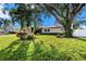 Landscaped front yard with lush grass and palm trees at 5857 25Th S St, St Petersburg, FL 33712