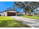 House exterior showcasing a large driveway and lush lawn at 5857 25Th S St, St Petersburg, FL 33712