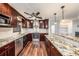 L-shaped kitchen with granite countertops and wood cabinets at 5857 25Th S St, St Petersburg, FL 33712