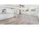 A spacious living room boasts light wood floors, white walls, and plenty of natural light from several windows at 5857 25Th S St, St Petersburg, FL 33712
