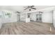 Bright living room features multiple ceiling fans, wood floors, and a counter overlooking a kitchen area at 5857 25Th S St, St Petersburg, FL 33712