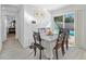 Bright dining area with wood table and chairs, opens to pool view at 6086 46Th N Ave, Kenneth City, FL 33709