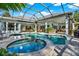 Inviting pool and spa with covered lanai and outdoor kitchen at 7041 Timber Ridge Way, Land O Lakes, FL 34637