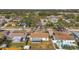 Aerial view showcasing a neighborhood with houses, yards, and a tree-lined street at 9126 109Th Ter, Seminole, FL 33777