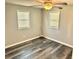 Simple bedroom with light gray walls and wood-look flooring at 9790 66Th N St # 74, Pinellas Park, FL 33782