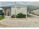 White mobile home with carport and landscaped area at 9790 66Th N St # 74, Pinellas Park, FL 33782