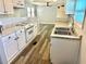 Renovated kitchen with white cabinets, granite counters, and stainless steel appliances at 9790 66Th N St # 74, Pinellas Park, FL 33782