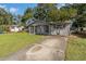 House exterior with gray brick and small front yard at 1025 Fairwood Ave, Clearwater, FL 33759